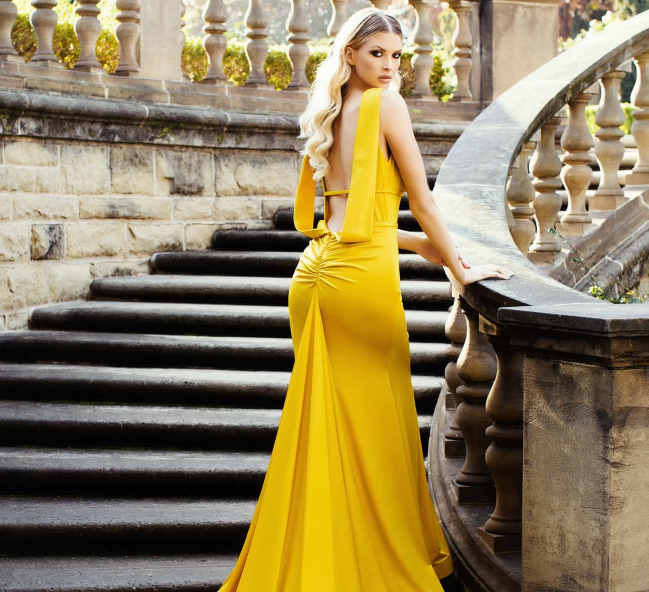 Model wearing a yellow gown. Mobile image