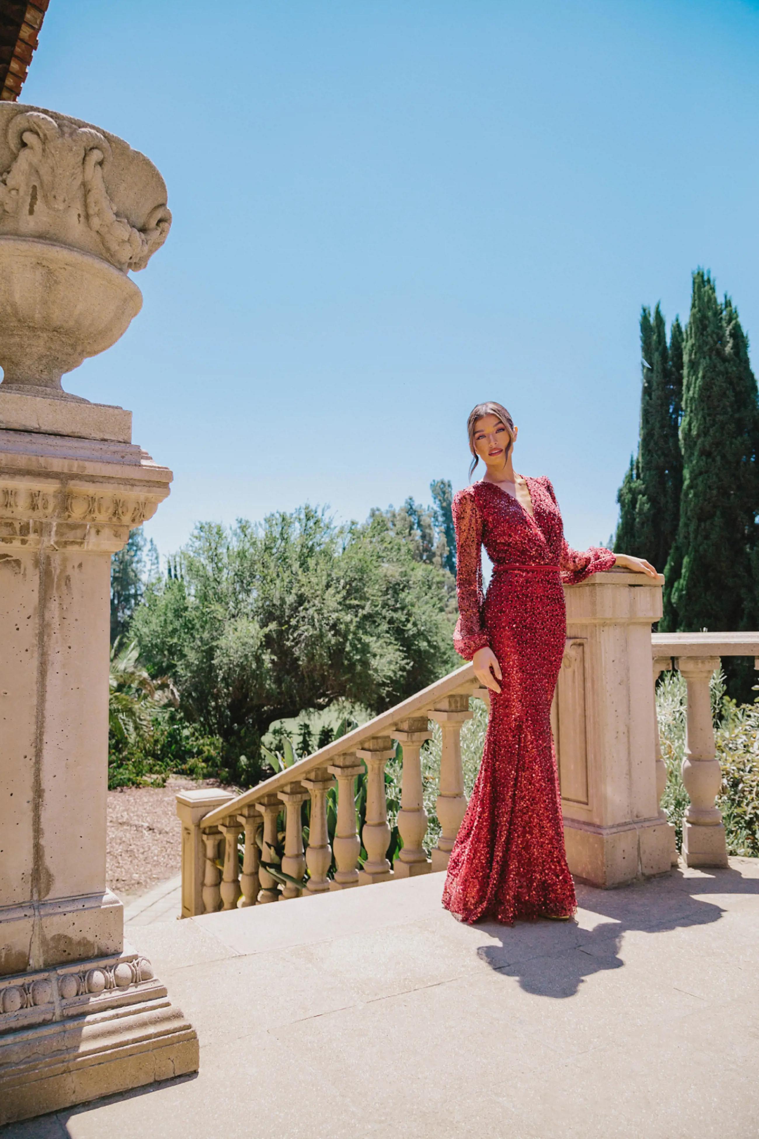 Model wearing a red long evening gown
