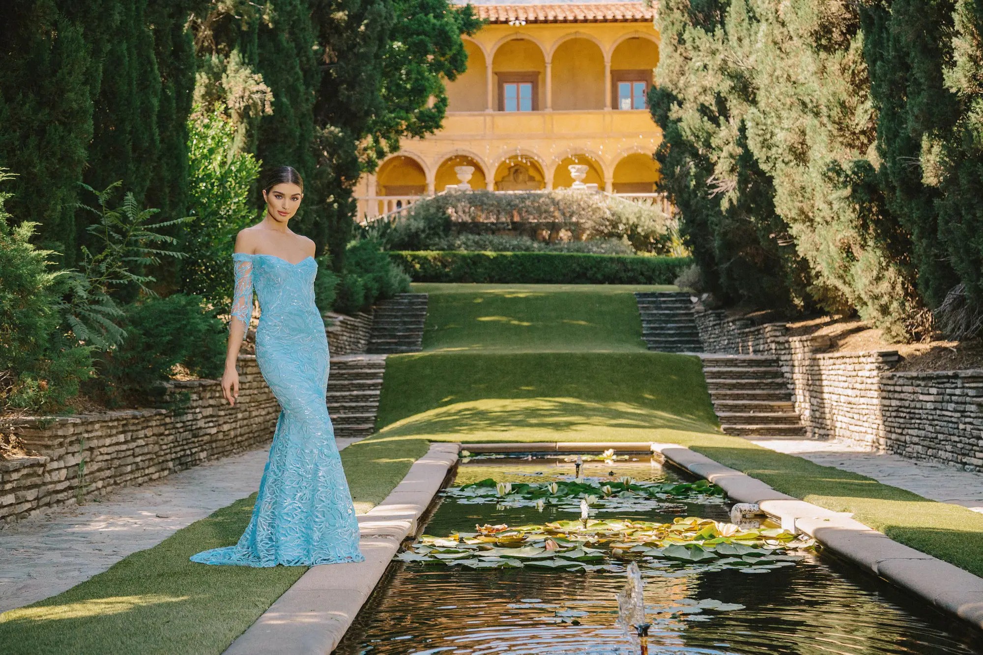 Model wearing a light blue evening gown